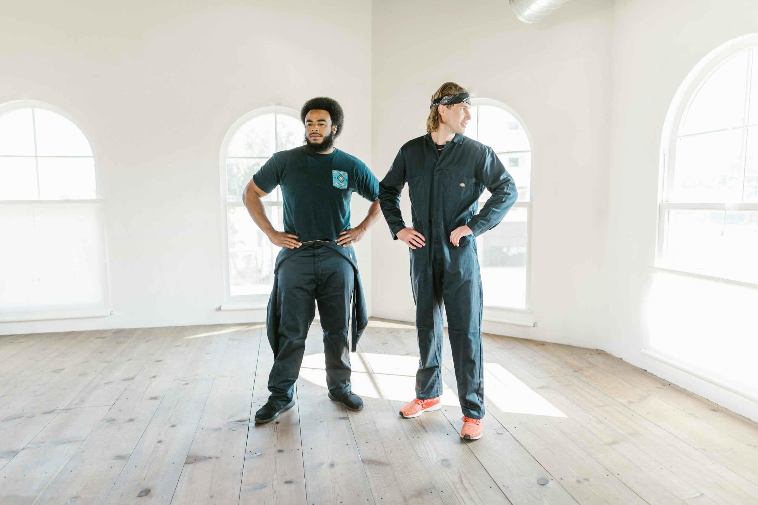 Men Standing Inside an Empty House while Looking Afar